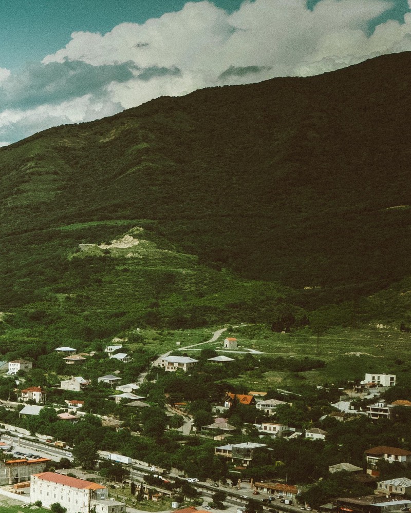 Hillside village beneath a mountain ridge